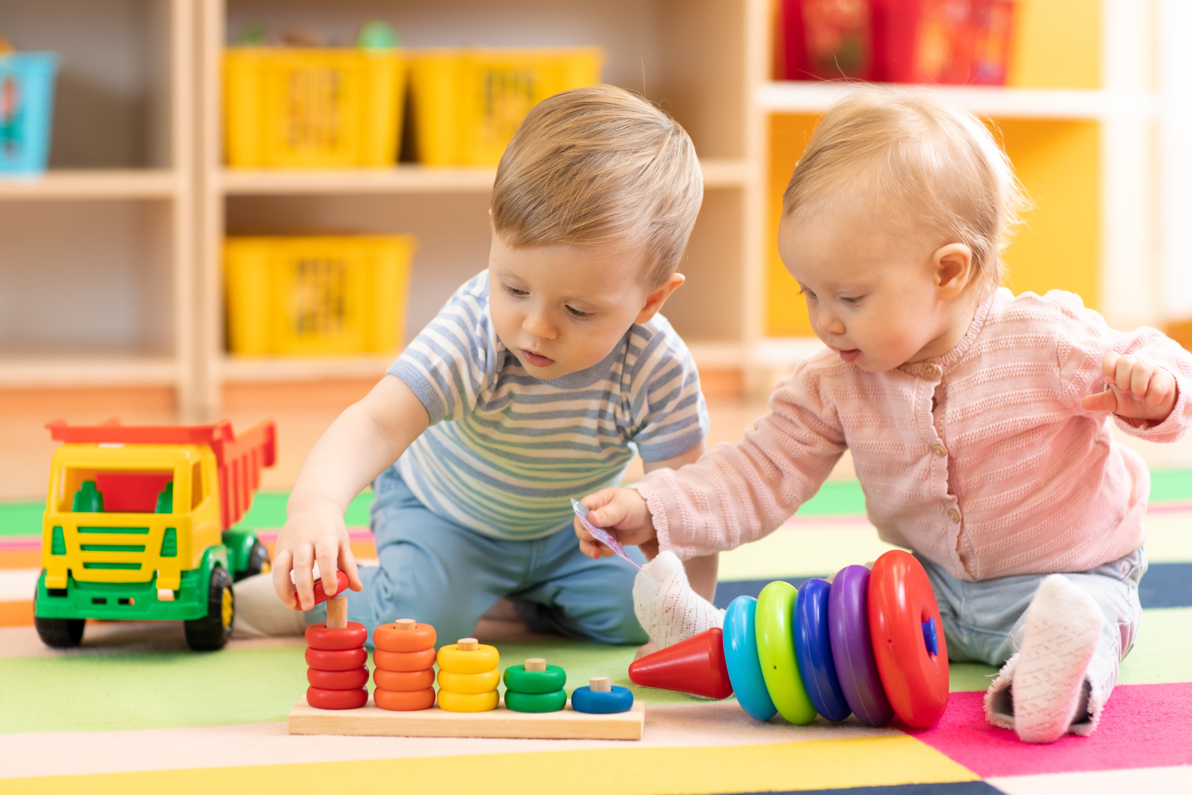 Young toddlers exploring a cozy classroom space at Bright Beginners Academy Bensalem